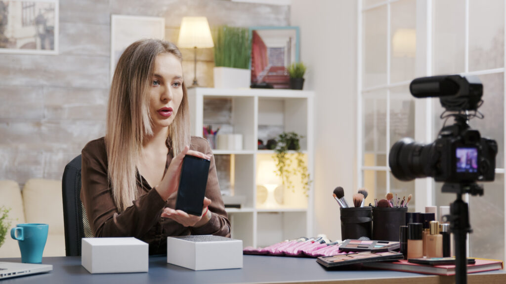 How to Sell on TikTok Shop: A Complete Guide 1 Famous beauty influencer recording unboxing for her vlog. Creative content creator.