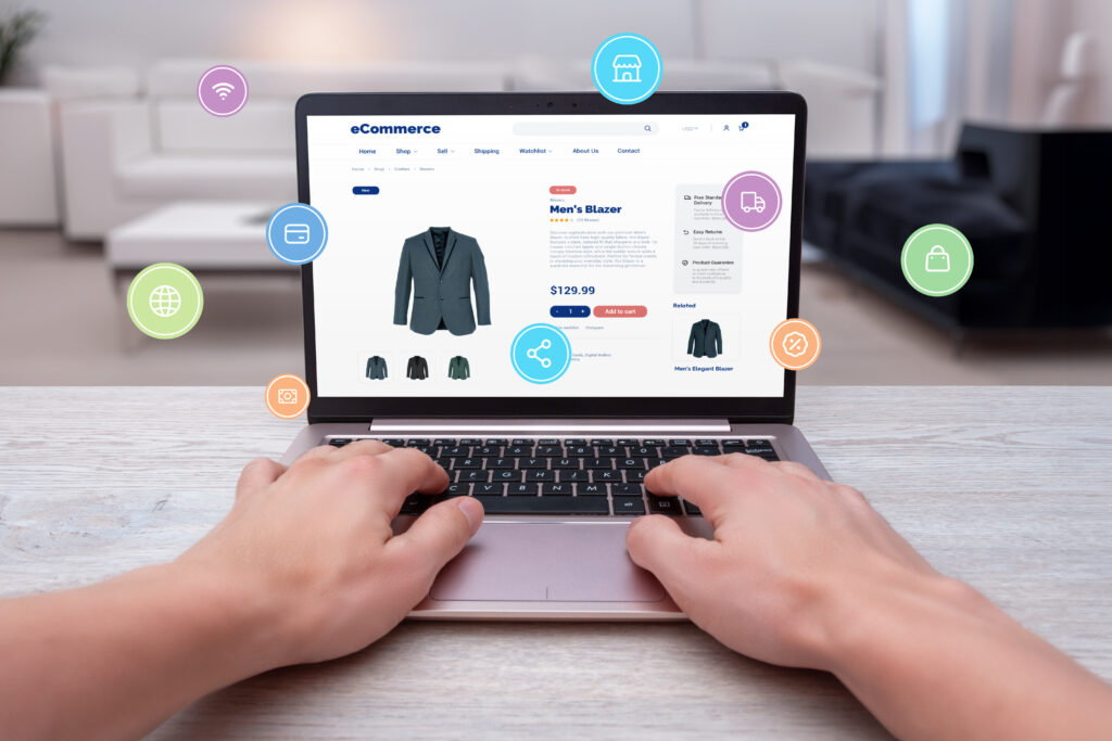 Why Start a Dropshipping Business in 2025: Tips, Tools, and Trends You Can't Miss 2 Hands typing on laptop, shopping online for men's blazer with levitating shopping icons. Modern concept of digital shopping convenience